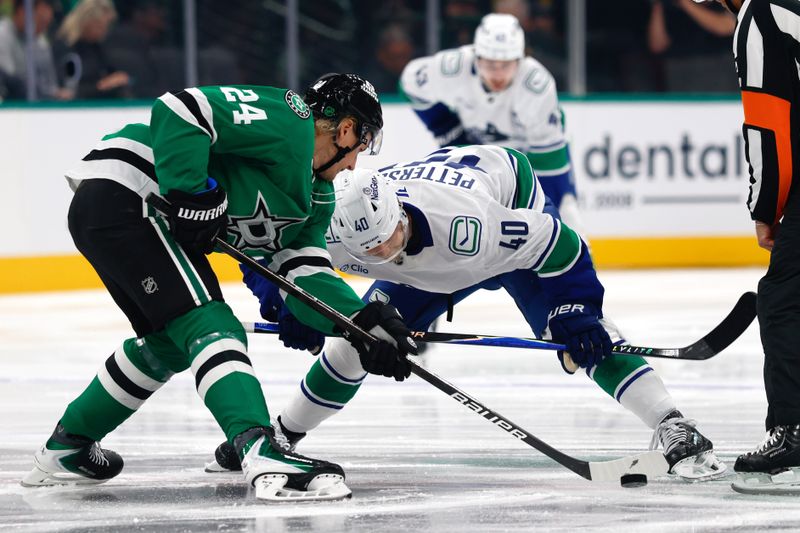 Oct 16, 2025; Dallas, Texas, USA; Dallas Stars center Roope Hintz (24) and Vancouver Canucks center Elias Pettersson (40) facefoff during the first period at American Airlines Center. Mandatory Credit: Chris Jones-Imagn Images