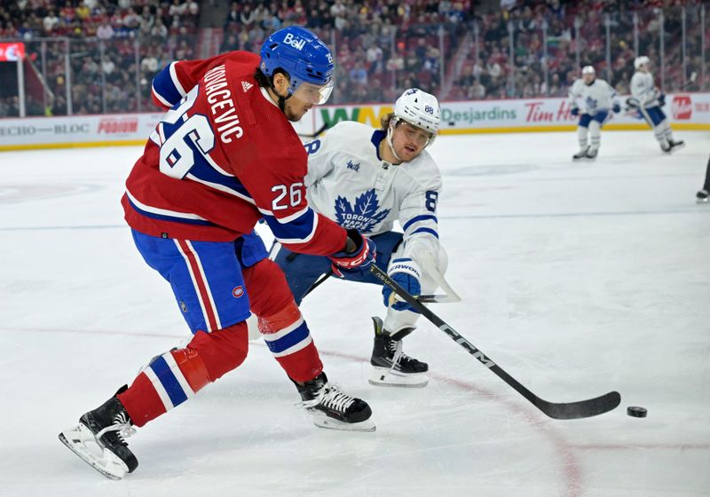 Apr 6, 2024; Montreal, Quebec, CAN; Montreal Canadiens defenseman Johnathan Kovacevic (26) plays the puck and Toronto Maple Leafs forward William Nylander (88) forechecks during the first period at the Bell Centre. Mandatory Credit: Eric Bolte-USA TODAY Sports