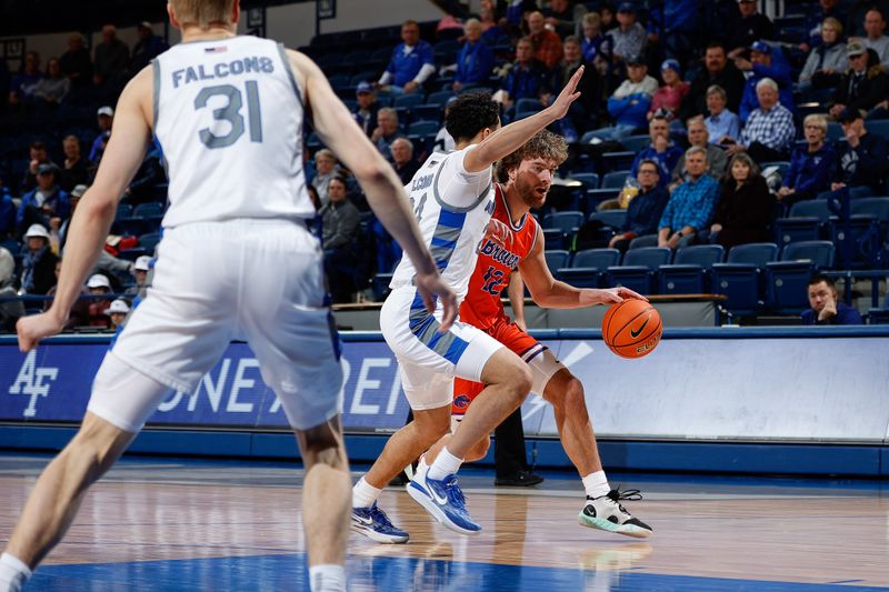 Jan 31, 2023; Colorado Springs, Colorado, USA; Boise State Broncos guard Max Rice (12) controls the ball against Air Force Falcons guard Jeffrey Mills (24) as forward Rytis Petraitis (31) defends in the first half at Clune Arena. Mandatory Credit: Isaiah J. Downing-USA TODAY Sports