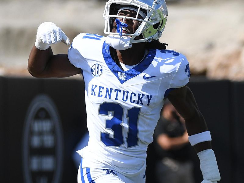 Sep 23, 2023; Nashville, Tennessee, USA; Kentucky Wildcats defensive back Maxwell Hairston (31) celebrates after returning an interception for a touchdown against the Vanderbilt Commodores during the first half at FirstBank Stadium. Mandatory Credit: Christopher Hanewinckel-USA TODAY Sports