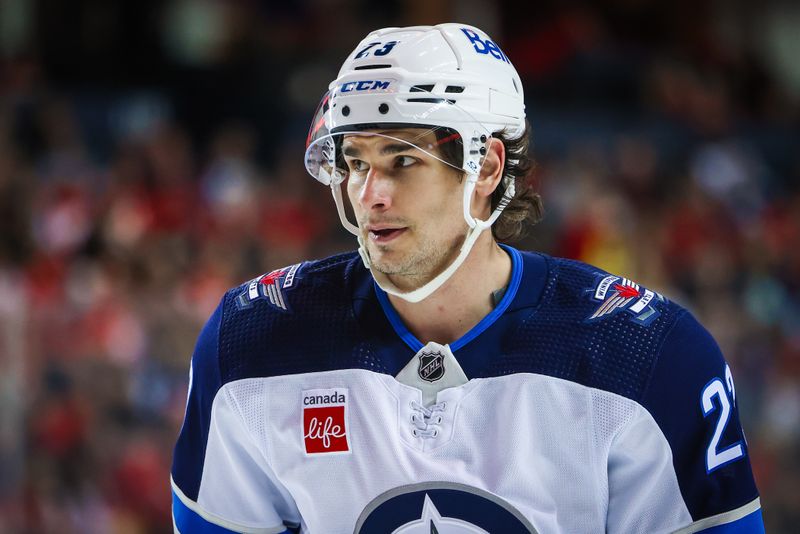 Feb 19, 2024; Calgary, Alberta, CAN; Winnipeg Jets center Sean Monahan (23) skates against the Calgary Flames during the first period at Scotiabank Saddledome. Mandatory Credit: Sergei Belski-USA TODAY Sports