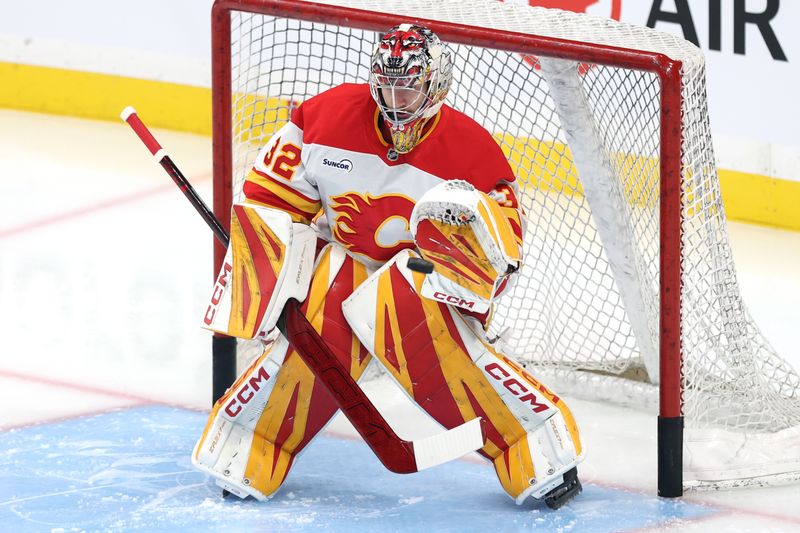 Oct 24, 2025; Winnipeg, Manitoba, CAN; Calgary Flames goaltender Dustin Wolf (32) warms up before a game against the Winnipeg Jets at Canada Life Centre. Mandatory Credit: James Carey Lauder-Imagn Images