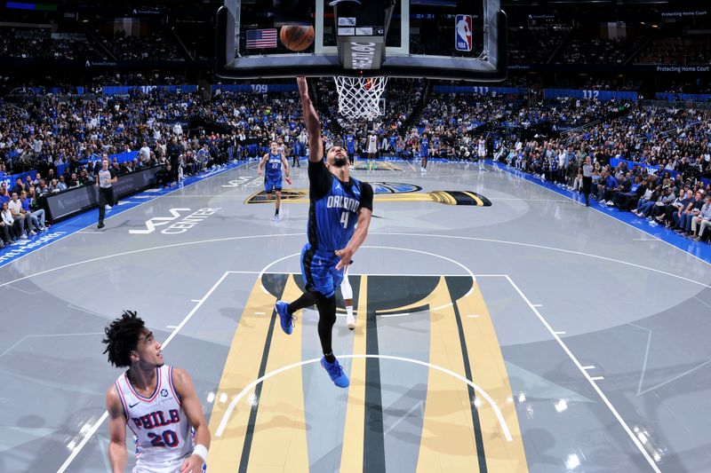 ORLANDO, FL - NOVEMBER 15: Jalen Suggs #4 of the Orlando Magic shoots the ball during the game against the Philadelphia 76ers during the Emirates NBA Cup game on  November 15, 2024 at Kia Center in Orlando, Florida. NOTE TO USER: User expressly acknowledges and agrees that, by downloading and or using this photograph, User is consenting to the terms and conditions of the Getty Images License Agreement. Mandatory Copyright Notice: Copyright 2024 NBAE (Photo by Fernando Medina/NBAE via Getty Images)