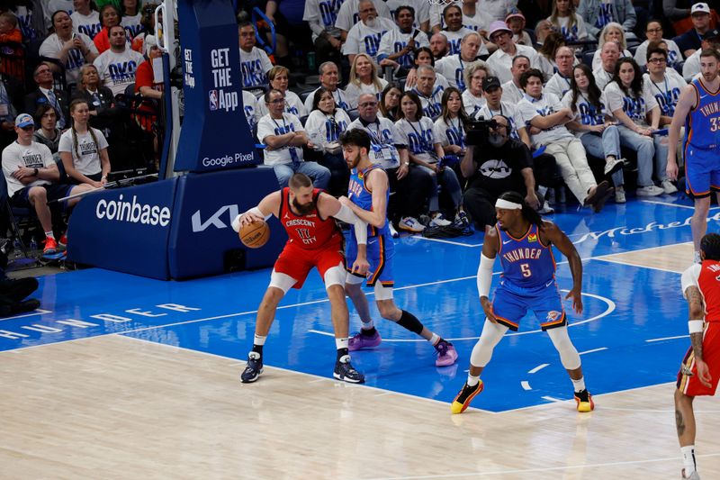 OKLAHOMA CITY, OK - APRIL 24: Jonas Valanciunas #17 of the New Orleans Pelicans dribbles the ball during the game against the Oklahoma City Thunder during Round 1 Game 2 of the 2024 NBA Playoffs on April 24, 2024 at Paycom Arena in Oklahoma City, Oklahoma. NOTE TO USER: User expressly acknowledges and agrees that, by downloading and or using this photograph, User is consenting to the terms and conditions of the Getty Images License Agreement. Mandatory Copyright Notice: Copyright 2024 NBAE (Photo by Martin McGrew/NBAE via Getty Images)