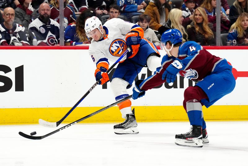 Jan 2, 2024; Denver, Colorado, USA; New York Islanders right wing Julien Gauthier (16) shoots the puck past Colorado Avalanche defenseman Bowen Byram (4) in the first period against at Ball Arena. Mandatory Credit: Ron Chenoy-USA TODAY Sports