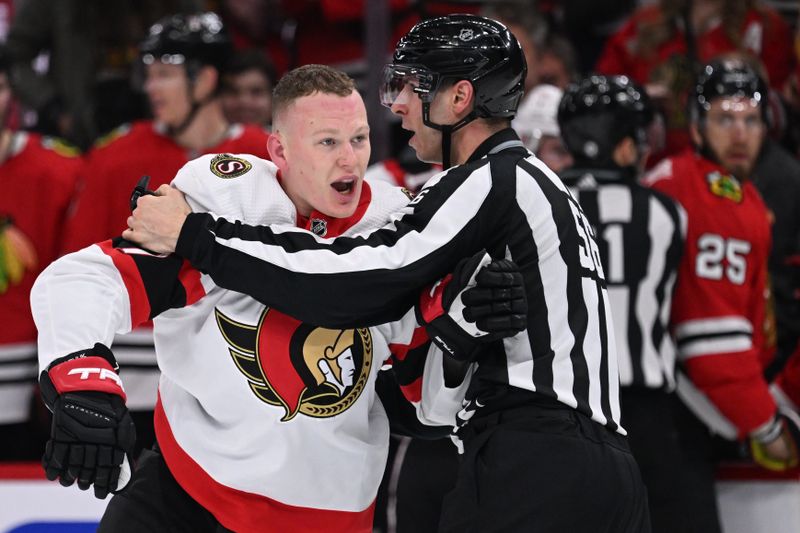 Mar 6, 2023; Chicago, Illinois, USA;  Ottawa Senators forward Brady Tkachuk (7) is held back by linesman Julien Fournier (56) as he shouts at the Chicago Blackhawks in the third period at United Center. Tkachuk was given a 10-minute misconduct penalty. Mandatory Credit: Jamie Sabau-USA TODAY Sports