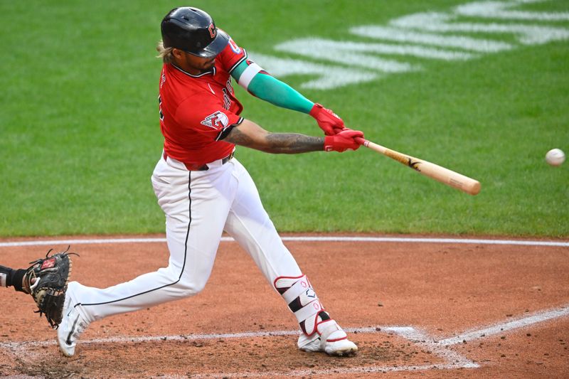 Jul 30, 2025; Cleveland, Ohio, USA; Cleveland Guardians shortstop Gabriel Arias (13) singles in the fourth inning against the Colorado Rockies at Progressive Field. Mandatory Credit: David Richard-Imagn Images