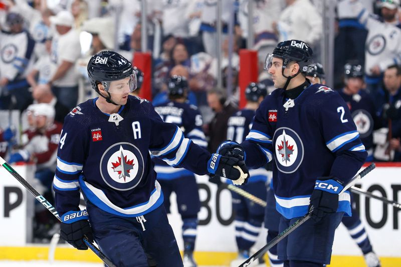 Apr 21, 2024; Winnipeg, Manitoba, CAN; Winnipeg Jets defenseman Josh Morrissey (44) celebrates his first period goal with Winnipeg Jets defenseman Dylan DeMelo (2) against the Colorado Avalanche in game one of the first round of the 2024 Stanley Cup Playoffs at Canada Life Centre. Mandatory Credit: James Carey Lauder-USA TODAY Sports