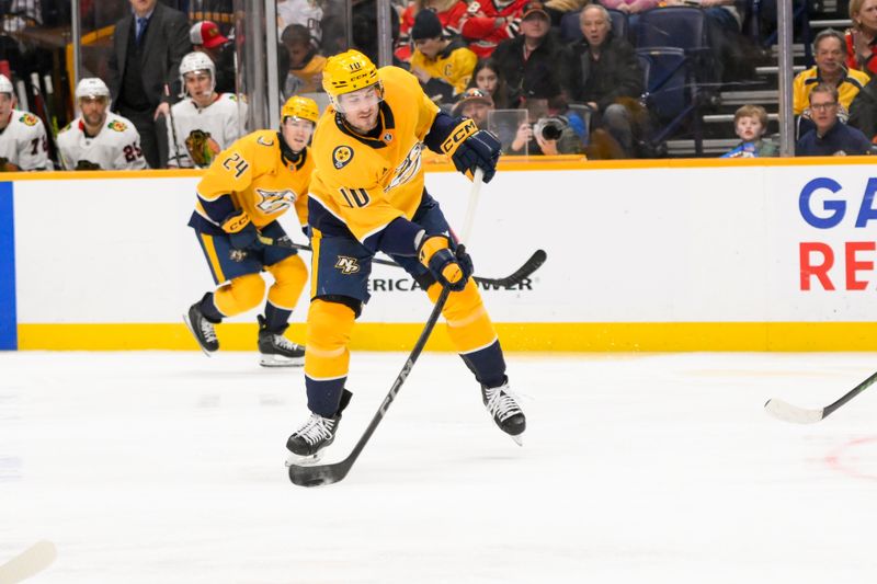 Jan 16, 2025; Nashville, Tennessee, USA;  Nashville Predators center Colton Sissons (10) takes a shot on goal against the Chicago Blackhawks during the third period at Bridgestone Arena. Mandatory Credit: Steve Roberts-Imagn Images