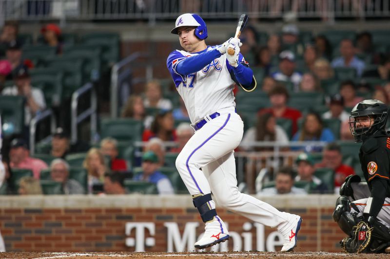 May 6, 2023; Atlanta, Georgia, USA; Atlanta Braves third baseman Austin Riley (27) hits a double against the Baltimore Orioles in the eighth inning at Truist Park. Mandatory Credit: Brett Davis-USA TODAY Sports
