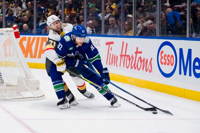 Nov 30, 2023; Vancouver, British Columbia, CAN; Vegas Golden Knights forward William Karlsson (71) stick checks Vancouver Canucks defenseman Ian Cole (82) in the first period at Rogers Arena. Mandatory Credit: Bob Frid-USA TODAY Sports