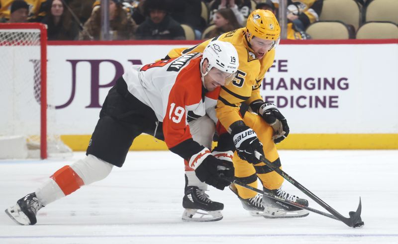 Jan 15, 2026; Pittsburgh, Pennsylvania, USA;  Philadelphia Flyers right wing Garnet Hathaway (19) and Pittsburgh Penguins defenseman Ryan Shea (5) battle for the puck during the third period at PPG Paints Arena. Mandatory Credit: Charles LeClaire-Imagn Images