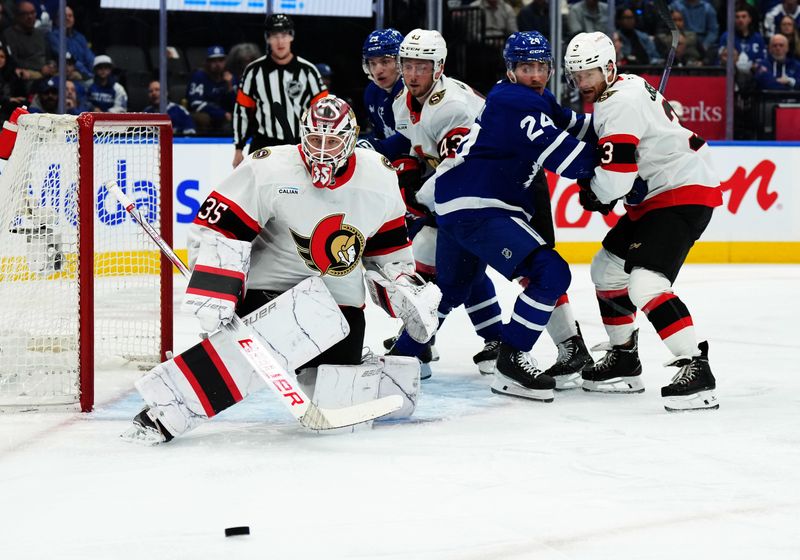 Nov 12, 2024; Toronto, Ontario, CAN; Toronto Maple Leafs center Connor Dewar (24) battles for the puck with Ottawa Senators defenseman Nick Jensen (3) in front of goaltender Linus Ullmark (35) during the first period at Scotiabank Arena. Mandatory Credit: Nick Turchiaro-Imagn Images