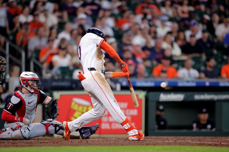 Jun 2, 2024; Houston, Texas, USA; Houston Astros designated hitter Kyle Tucker (30) hits a single against the Minnesota Twins during the third inning at Minute Maid Park. Mandatory Credit: Erik Williams-USA TODAY Sports