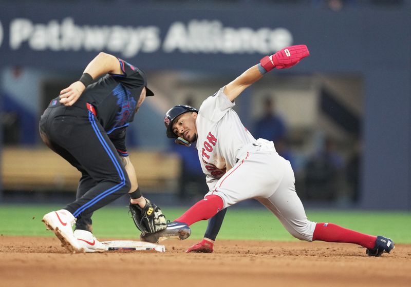 Jun 19, 2024; Toronto, Ontario, CAN; Boston Red Sox shortstop David Hamilton (70) steals second base ahead of the tag from Toronto Blue Jays second base Spencer Horwitz (48) during the fifth inning at Rogers Centre. Mandatory Credit: Nick Turchiaro-USA TODAY Sports