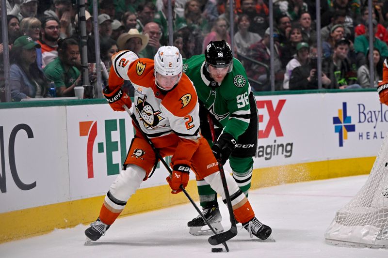 Mar 18, 2025; Dallas, Texas, USA; Anaheim Ducks defenseman Jackson LaCombe (2) and Dallas Stars right wing Mikko Rantanen (96) battle for control of the puck during the second period at the American Airlines Center. Mandatory Credit: Jerome Miron-Imagn Images