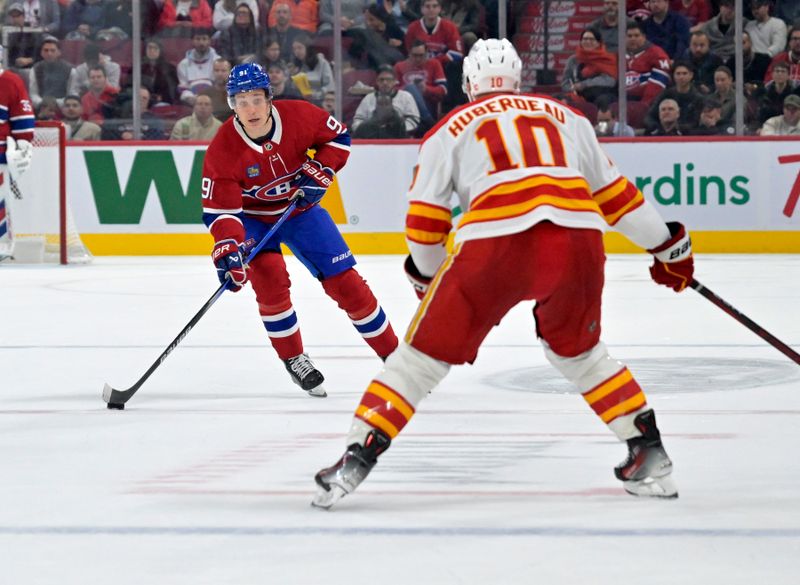 Nov 5, 2024; Montreal, Quebec, CAN; Montreal Canadiens forward Oliver Kapanen (91) plays the puck and Calgary Flames forward Jonathan Huberdeau (10) defends during the second period at the Bell Centre. Mandatory Credit: Eric Bolte-Imagn Images