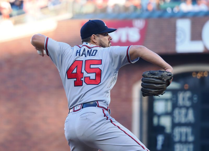 Aug 27, 2023; San Francisco, California, USA; Atlanta Braves relief pitcher Brad Hand (45) pitches the ball against the San Francisco Giants during the eighth inning at Oracle Park. Mandatory Credit: Kelley L Cox-USA TODAY Sports