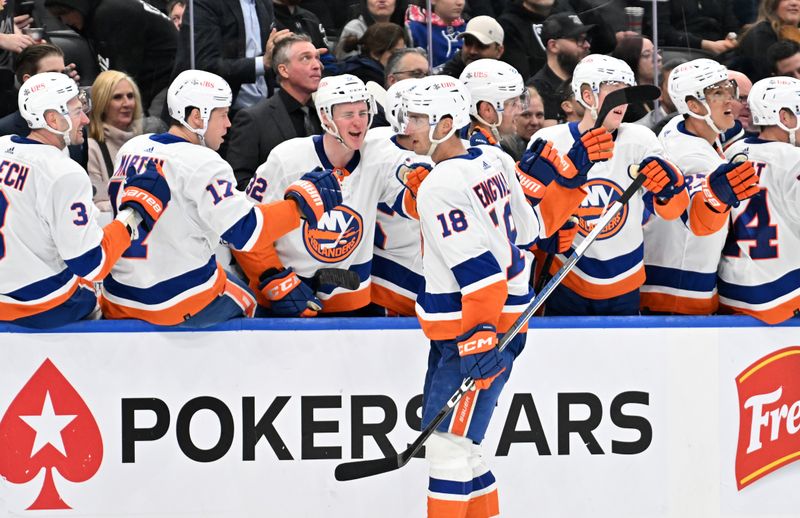 Feb 5, 2024; Toronto, Ontario, CAN;   New York Islanders forward Pierre Engvall (18) celebrates with team mates at the bench after scoring a goal against the Toronto Maple Leafs in the third period at Scotiabank Arena. Mandatory Credit: Dan Hamilton-USA TODAY Sports