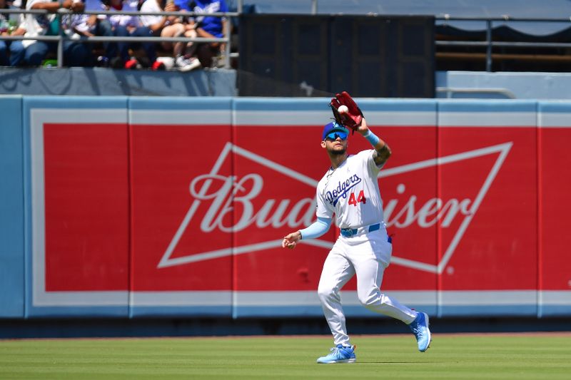 Jun 16, 2024; Los Angeles, California, USA; Los Angeles Dodgers center fielder Andy Pages (44) catches the fly ball of Kansas City Royals right fielder Adam Frazier (26) during the seventh inning at Dodger Stadium. Mandatory Credit: Gary A. Vasquez-USA TODAY Sports