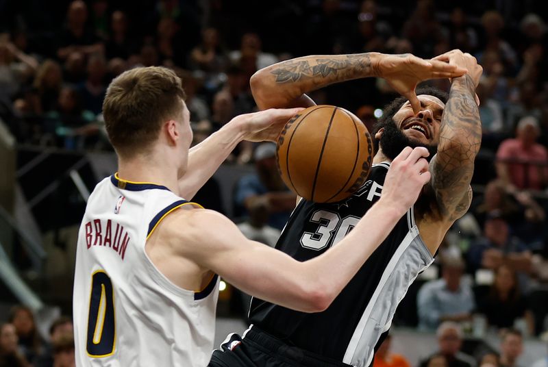 SAN ANTONIO, TX - APRIL 12: Christian Braun #0 of the Denver Nuggets knocks the ball loose from Julian Champagne #30 of the San Antonio Spurs in the first half at Frost Bank Center on April 12, 2024 in San Antonio, Texas. NOTE TO USER: User expressly acknowledges and agrees that, by downloading and or using this photograph, User is consenting to terms and conditions of the Getty Images License Agreement. (Photo by Ronald Cortes/Getty Images)