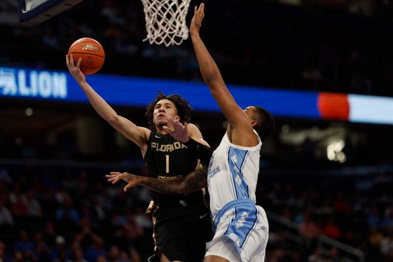 Mar 14, 2024; Washington, D.C., USA; Florida State guard Jalen Warley (1) shoots the ball as North Carolina forward Armando Bacot (5) defends in the first half at Capital One Arena. Mandatory Credit: Geoff Burke-USA TODAY Sports