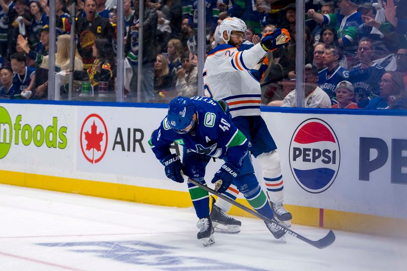 May 10, 2024; Vancouver, British Columbia, CAN; Edmonton Oilers defenseman Darnell Nurse (25) checks Vancouver Canucks forward Elias Pettersson (40) during the first period in game two of the second round of the 2024 Stanley Cup Playoffs at Rogers Arena. Mandatory Credit: Bob Frid-USA TODAY Sports