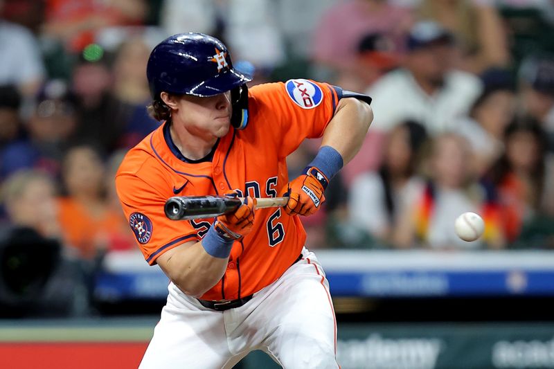 May 9, 2025; Houston, Texas, USA; Houston Astros center fielder Jake Meyers (6) bunts against the Cincinnati Reds during the fourth inning at Daikin Park. Mandatory Credit: Erik Williams-Imagn Images