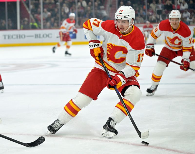 Nov 5, 2024; Montreal, Quebec, CAN; Calgary Flames forward Yegor Sharangovich (17) plays the puck during the first period of the game against the Montreal Canadiens at the Bell Centre. Mandatory Credit: Eric Bolte-Imagn Images