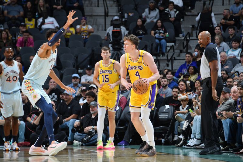 SAN ANTONIO, TX - NOVEMBER 27: Dalton Knecht #4 of the Los Angeles Lakers dribbles the ball during the game against the San Antonio Spurs on November 27, 2024 at the Frost Bank Center in San Antonio, Texas. NOTE TO USER: User expressly acknowledges and agrees that, by downloading and or using this photograph, user is consenting to the terms and conditions of the Getty Images License Agreement. Mandatory Copyright Notice: Copyright 2024 NBAE (Photos by Michael Gonzales/NBAE via Getty Images)