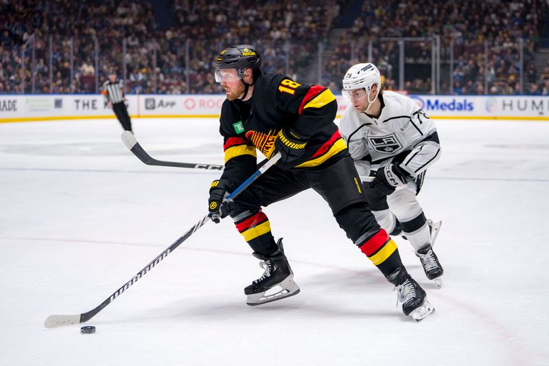 Mar 25, 2024; Vancouver, British Columbia, CAN; Vancouver Canucks forward Sam Lafferty (18) drives around Los Angeles Kings forward Alex Laferriere (78) in the first period at Rogers Arena. Mandatory Credit: Bob Frid-USA TODAY Sports