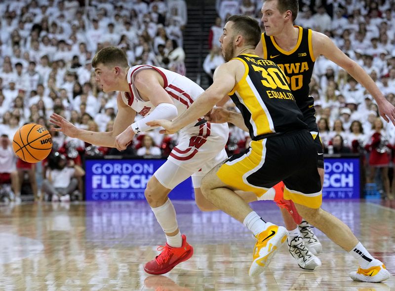 Feb 22, 2023; Madison, Wisconsin, USA; Wisconsin guard Connor Essegian (3) gets past Iowa guard Connor McCaffery (30) during the second half at Kohl Center. Mandatory Credit: Mark Hoffman-USA TODAY Sports