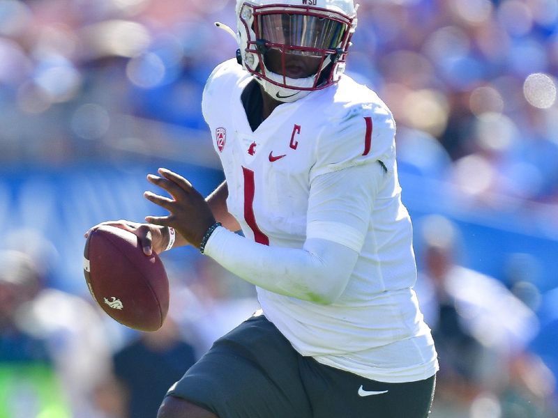 Oct 7, 2023; Pasadena, California, USA; Washington State Cougars quarterback Cameron Ward (1) runs the ball against the UCLA Bruins during the second half at Rose Bowl. Mandatory Credit: Gary A. Vasquez-USA TODAY Sports