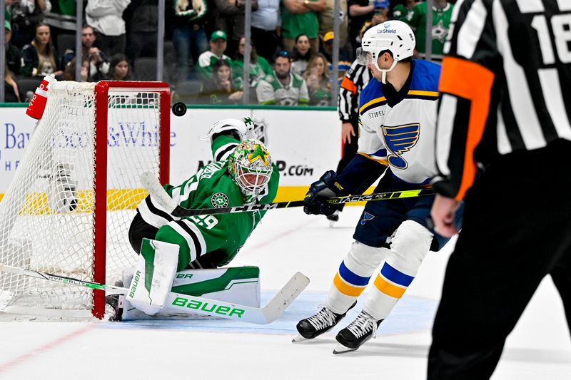 Apr 17, 2024; Dallas, Texas, USA; St. Louis Blues center Jordan Kyrou (25) looks on as his shot hits the crossbar behind Dallas Stars goaltender Jake Oettinger (29) during the overtime shootout at the American Airlines Center. Mandatory Credit: Jerome Miron-USA TODAY Sports