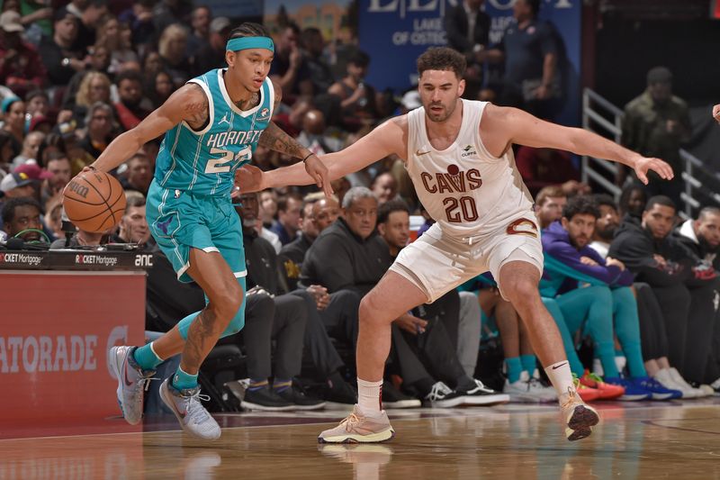 CLEVELAND, OH - APRIL 14: Georges Niang #20 of the Cleveland Cavaliers plays defense against Tre Mann #23 of the Charlotte Hornets on April 14, 2024 at Rocket Mortgage FieldHouse in Cleveland, Ohio. NOTE TO USER: User expressly acknowledges and agrees that, by downloading and/or using this Photograph, user is consenting to the terms and conditions of the Getty Images License Agreement. Mandatory Copyright Notice: Copyright 2024 NBAE (Photo by David Liam Kyle/NBAE via Getty Images)