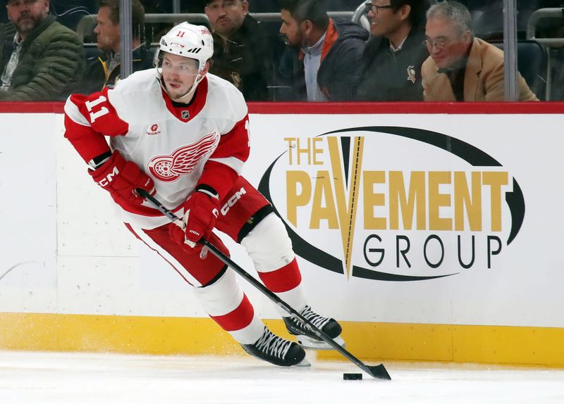 Nov 13, 2024; Pittsburgh, Pennsylvania, USA;  Detroit Red Wings right wing Vladimir Tarasenko (11) skates with the puck against the Pittsburgh Penguins during the third period at PPG Paints Arena. Mandatory Credit: Charles LeClaire-Imagn Images