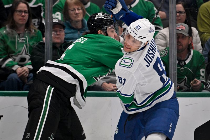 Jan 31, 2025; Dallas, Texas, USA; Dallas Stars defenseman Lian Bichsel (6) checks Vancouver Canucks center Dakota Joshua (81) during the first period at the American Airlines Center. Mandatory Credit: Jerome Miron-Imagn Images