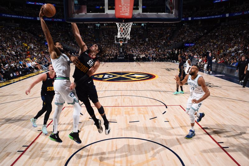 DENVER, CO - MAY 19:  Karl-Anthony Towns #32 of the Minnesota Timberwolves goes to the basket during the game against Aaron Gordon #50 of the Denver Nuggets during Round 2 Game 7 of the 2024 NBA Playoffs  on May 19, 2024 at the Ball Arena in Denver, Colorado. NOTE TO USER: User expressly acknowledges and agrees that, by downloading and/or using this Photograph, user is consenting to the terms and conditions of the Getty Images License Agreement. Mandatory Copyright Notice: Copyright 2024 NBAE (Photo by Garrett Ellwood/NBAE via Getty Images)