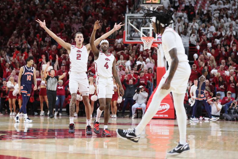 Jan 6, 2024; Fayetteville, Arkansas, USA; Arkansas Razorbacks forward Trevon Brazile (2) and guard Davonte Davis (4) celebrate after a three point shot by guard Keyon Menifield Jr (1) in the first half against the Auburn Tigers at Bud Walton Arena. Mandatory Credit: Nelson Chenault-USA TODAY Sports