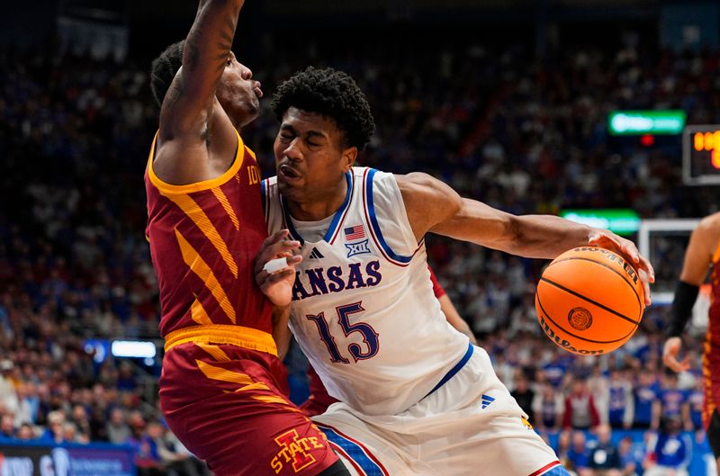 Jan 13, 2026; Lawrence, Kansas, USA; Kansas Jayhawks forward Bryson Tiller (15) drives against Iowa State Cyclones guard Jamarion Batemon (1) during the second half at Allen Fieldhouse. Mandatory Credit: Jay Biggerstaff-Imagn Images