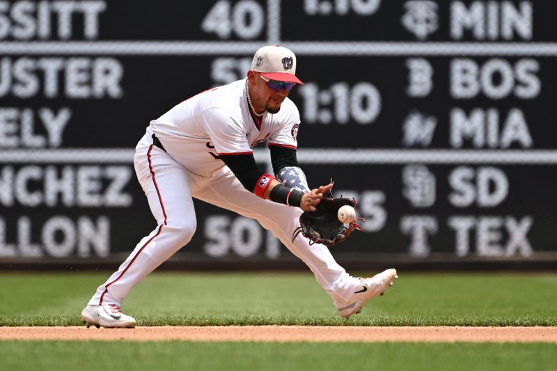 Jul 4, 2024; Washington, District of Columbia, USA; Washington Nationals second baseman Ildemaro Vargas (14) fields a ground ball against the New York Mets during the seventh inning at Nationals Park. Mandatory Credit: Rafael Suanes-USA TODAY Sports