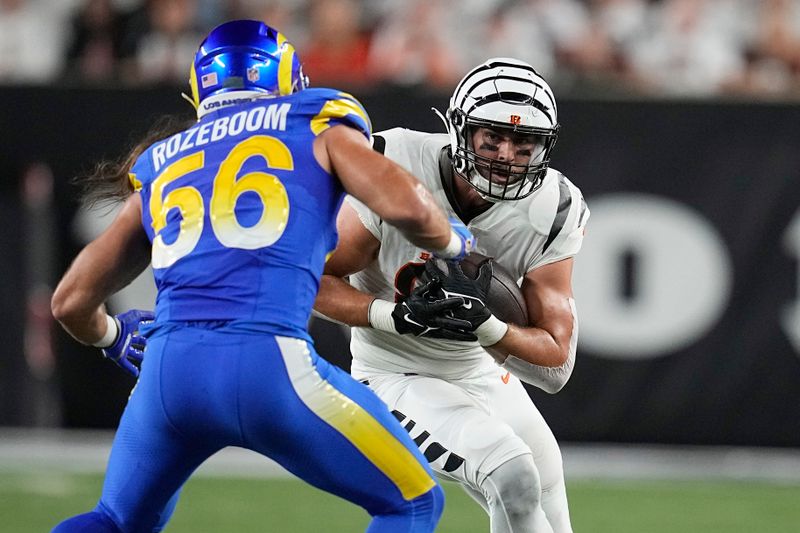 Cincinnati Bengals tight end Mitchell Wilcox runs with the ball as Los Angeles Rams linebacker Christian Rozeboom (56) defends during the first half of an NFL football game Monday, Sept. 25, 2023, in Cincinnati. (AP Photo/Darron Cummings)