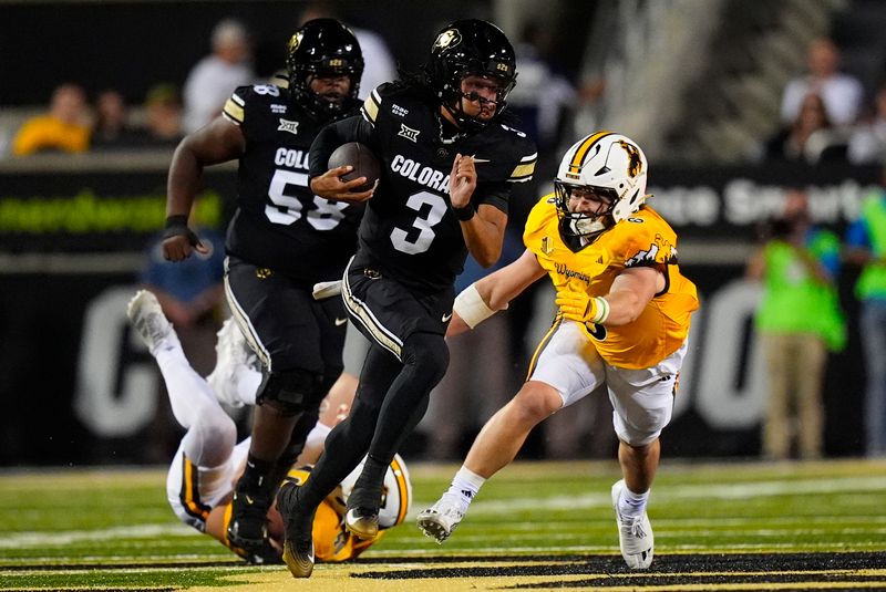 Sep 20, 2025; Boulder, Colorado, USA; Colorado Buffaloes quarterback Kaidon Salter (3) scrambles with the ball as Wyoming Cowboys linebacker Evan Eller (6) chases in first quarter at Folsom Field. Mandatory Credit: Ron Chenoy-Imagn Images