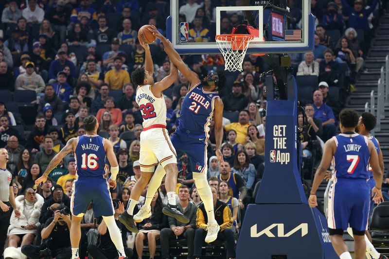 SAN FRANCISCO, CALIFORNIA - JANUARY 02: Joel Embiid #21 of the Philadelphia 76ers blocks a shot attempt by Trayce Jackson-Davis #32 of the Golden State Warriors in the first half at Chase Center on January 02, 2025 in San Francisco, California. NOTE TO USER: User expressly acknowledges and agrees that, by downloading and/or using this photograph, user is consenting to the terms and conditions of the Getty Images License Agreement.   (Photo by Ezra Shaw/Getty Images)