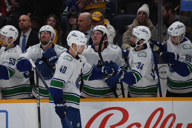 Dec 19, 2023; Nashville, Tennessee, USA; Vancouver Canucks center Elias Pettersson (40) is congratulated by teammates after a goal during the first period against the Nashville Predators at Bridgestone Arena. Mandatory Credit: Christopher Hanewinckel-USA TODAY Sports