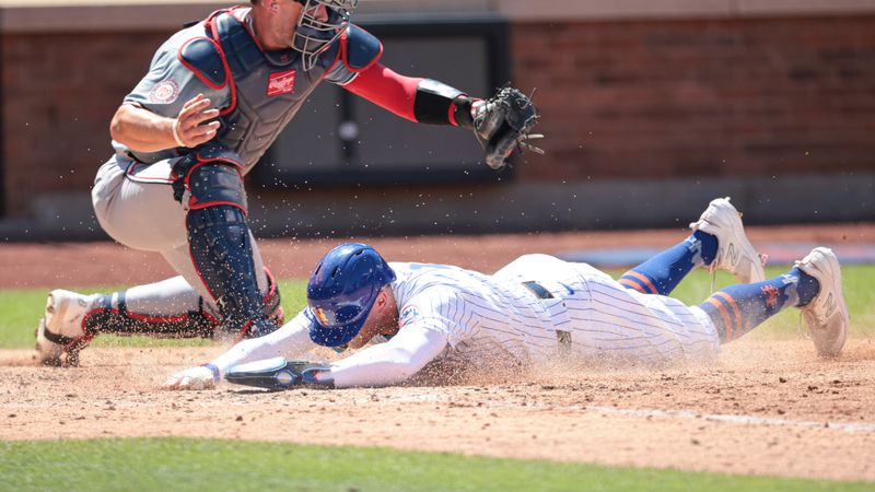 Jul 11, 2024; New York City, New York, USA; New York Mets left fielder Brandon Nimmo (9) scores a run under the tag by Washington Nationals catcher Riley Adams (15) during the fifth inning at Citi Field. Mandatory Credit: Vincent Carchietta-USA TODAY Sports