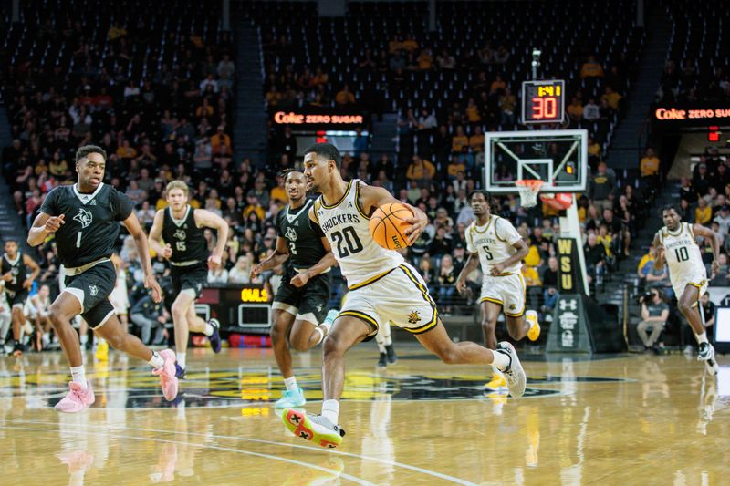 Mar 2, 2024; Wichita, Kansas, USA; Wichita State Shockers guard Harlond Beverly (20) brings the ball up court around Rice Owls guard Mekhi Mason (2) during the first half at Charles Koch Arena. Mandatory Credit: William Purnell-USA TODAY Sports