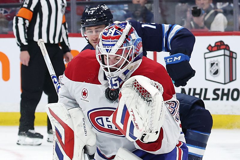 Dec 14, 2024; Winnipeg, Manitoba, CAN; Montreal Canadiens goaltender Sam Montembeault (35) blocks a shot in the second period against the Winnipeg Jets at Canada Life Centre. Mandatory Credit: James Carey Lauder-Imagn Images