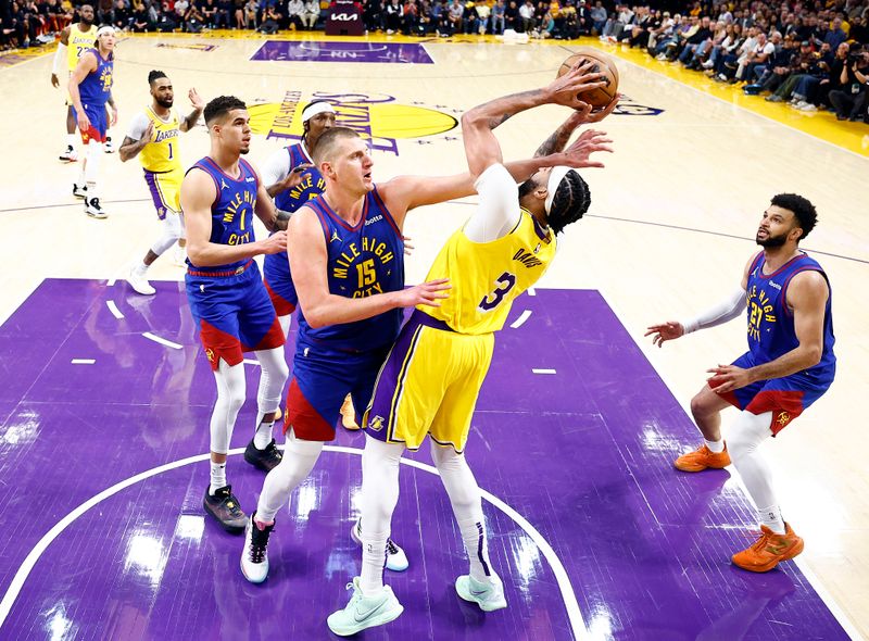 LOS ANGELES, CALIFORNIA - APRIL 25:  Anthony Davis #3 of the Los Angeles Lakers takes a shot against Nikola Jokic #15 of the Denver Nuggets in the first quarter during game three of the Western Conference First Round Playoffs at Crypto.com Arena on April 25, 2024 in Los Angeles, California.  (Photo by Ronald Martinez/Getty Images)