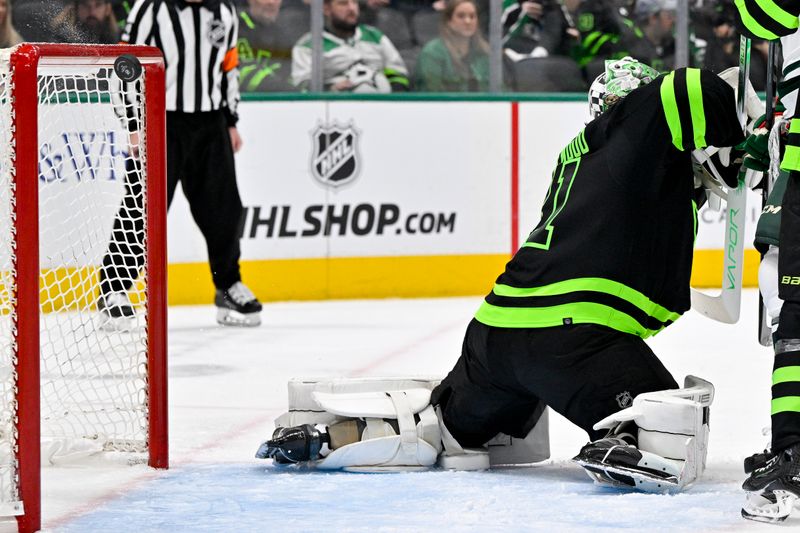 Jan 10, 2024; Dallas, Texas, USA; A view of the puck as it hits the crossbar behind Dallas Stars goaltender Scott Wedgewood (41) during the third period against the Minnesota Wild at the American Airlines Center. Mandatory Credit: Jerome Miron-USA TODAY Sports